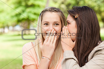 Close-up of teenagers sharing a secret