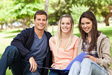 Portrait of three teenagers studying together