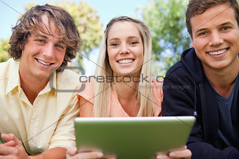 Portrait of three students using a tactile tablet