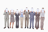 Business people hiding their faces with support for letters