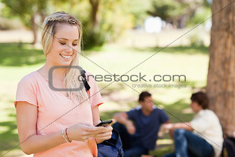 Close-up of a smiling girl using a smartphone