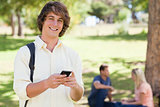 Portrait of a young man holding a smartphone
