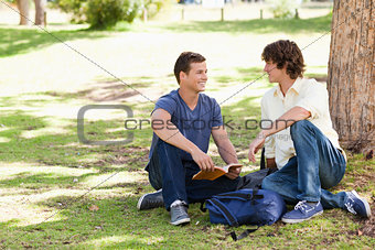 Portrait of two male students talking