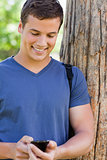 Close-up of a muscled young man using a smartphone