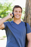 Portrait of a muscled young man on the phone
