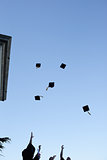 Grad students throwing their hats in the sky 