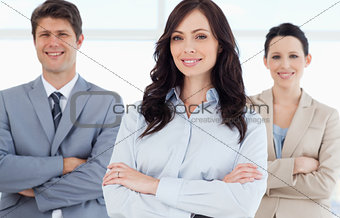 Young smiling executive woman crossing her arms in front of two 