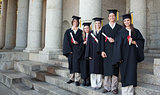 Five happy graduates posing