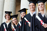 Close-up of five graduates posing