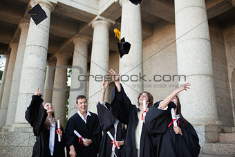 Graduates throwing their hats in the sky 