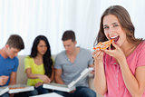 A woman in front of her friends as she is about to eat a slice o