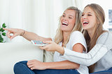 Sisters laughing at the tv together