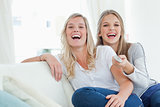 Laughing sisters sitting on the couch