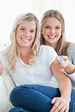 Close up of laughing sisters sitting on the couch
