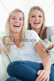 Close up of laughing girls watching tv