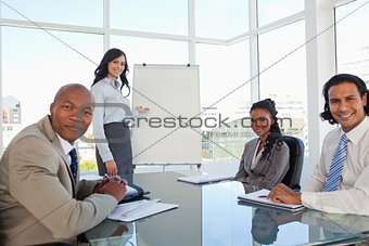 Smiling businesswoman giving a presentation to her relaxed colle