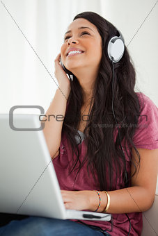 Close-up of a happy Latino student enjoying music