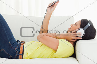 Young woman watching a video with earphones 