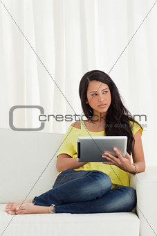 Beautiful Latino with a blank stare while using a touch pad