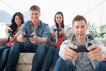 A group of friends playing games while looking at the camera