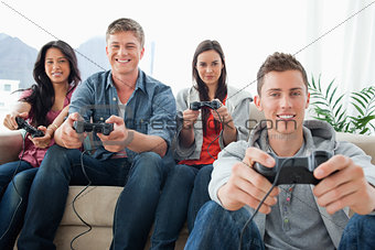 A happy group of friends playing games together while looking at