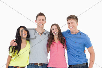 A laughing group of friends look at the camera 