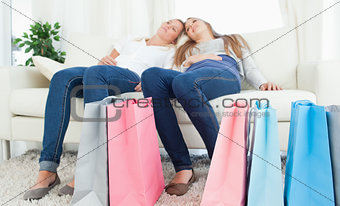 A pair of sisters exhausted after shopping