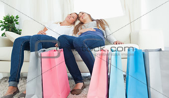 A couple of girls sitting after a hard day of shopping