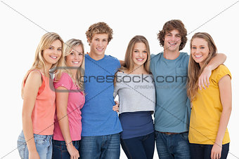 A group of friends smiling and holding each other