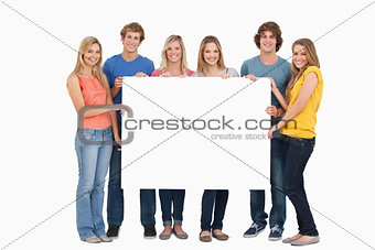 A group of people holding blank sheet