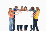 A group holding a blank sheet and pointing to it