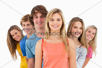 Smiling group standing behind one another at various angles