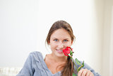 Woman holding a rose while smiling