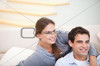 Couple looking away while embracing