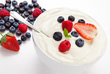 Bowl of cream with different berries