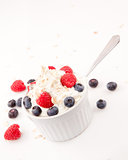 Whipped cream mix with berries and spoon