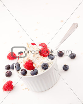 Whipped cream mix with berries and spoon