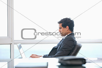 Man typing on a computer 