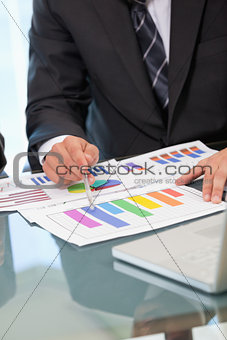 Men pointing a graph with a pen