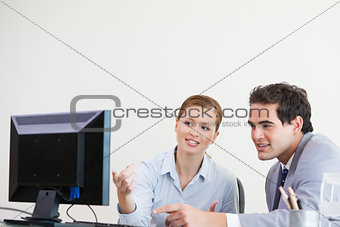 Colleagues pointing something on a computer