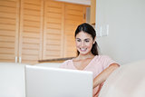 Woman smiling while using a computer
