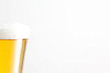 Glass of beer and foam against a white background
