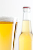 Glass and bottle of beer against a white background