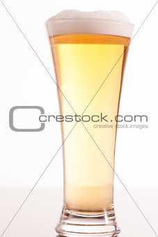 Full glass filled with beer and foam