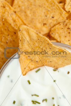 Close up of a bowl of white dip with herbs