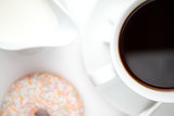 Cup of coffee with a doughnut