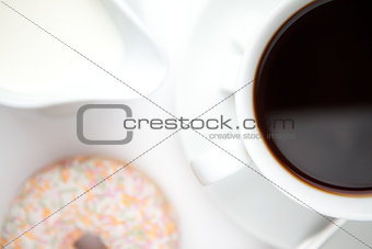Cup of coffee with a doughnut