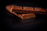 Two blurred bar of dark chocolate