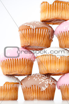 Close up on eight muffins with icing sugar placed in pyramid