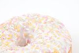 Close up on doughnut with multi coloured icing sugar